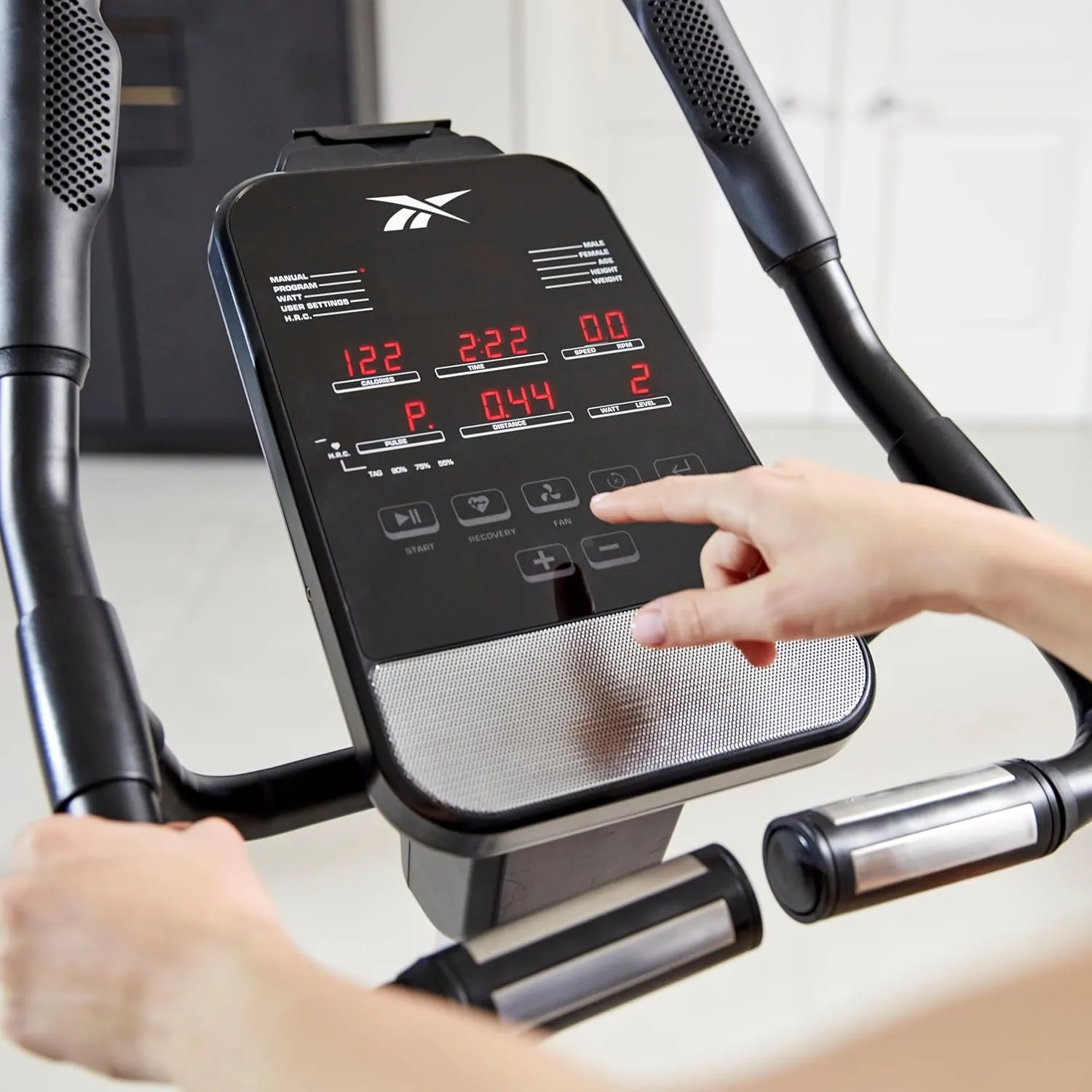 Reebok Fitness Stationary Bike: Bluetooth Compatible Indoor Cycling Bike, 24 Resistance Levels, 12 Workouts, Upright Exercise Bike with Gel Pad Saddle