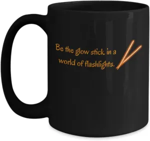 Shine Bright Be the glow stick in a world of flashlights black mug orange, ceramic 11 or 15 oz.